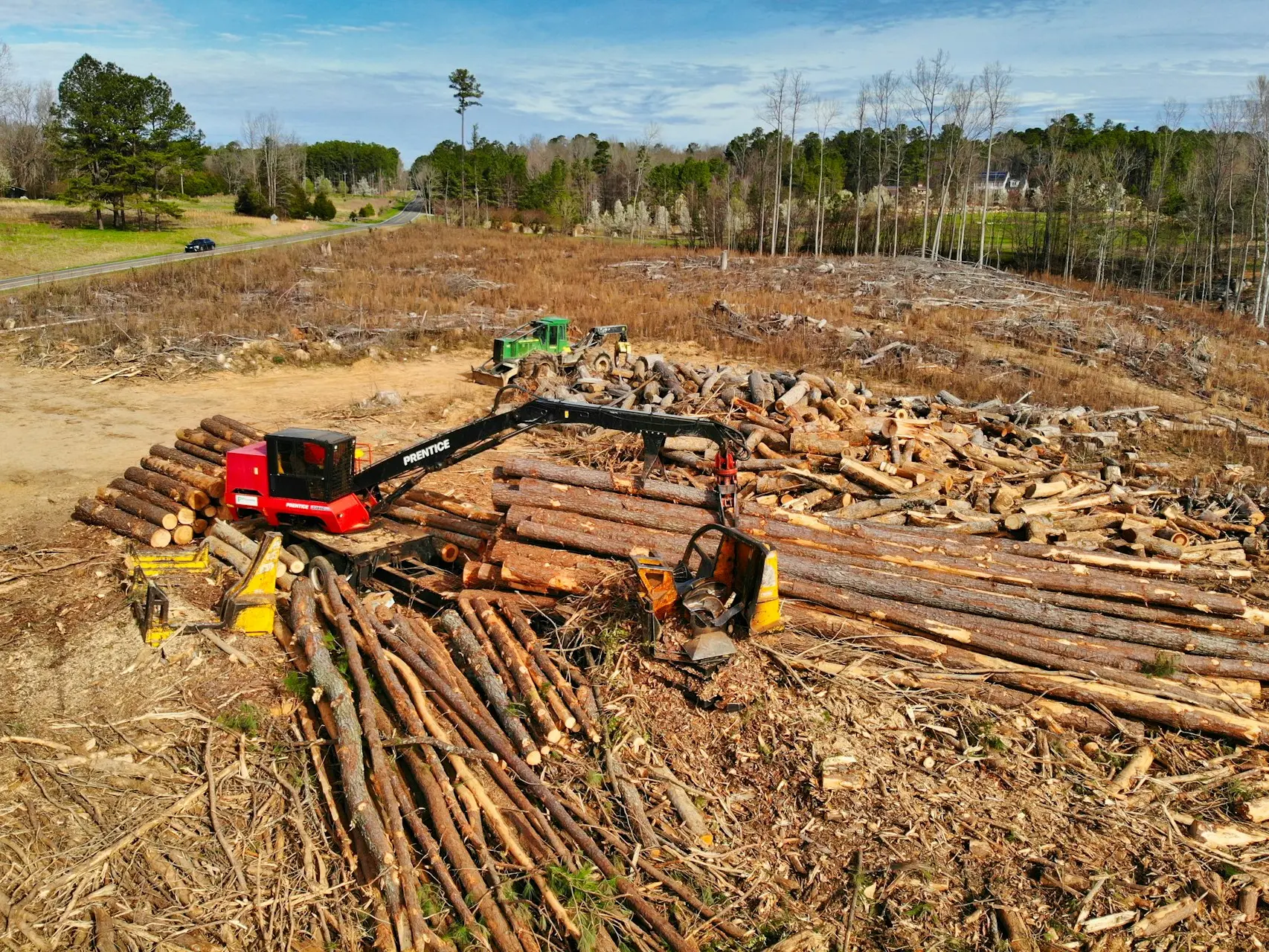 red and black heavy equipment on brown soil